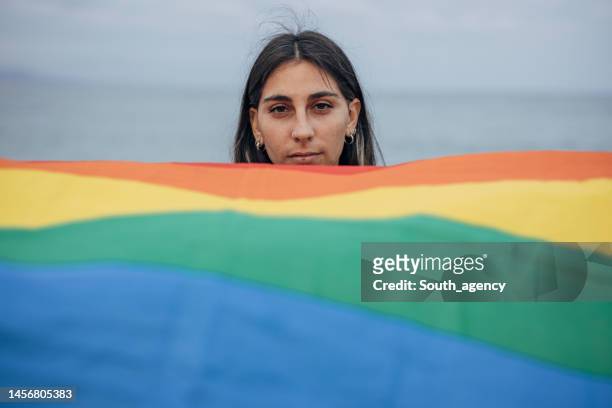 woman with pride flag - gay pride flag stock pictures, royalty-free photos & images