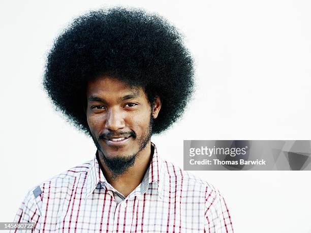 male standing against white background smiling - afro frisur stock-fotos und bilder