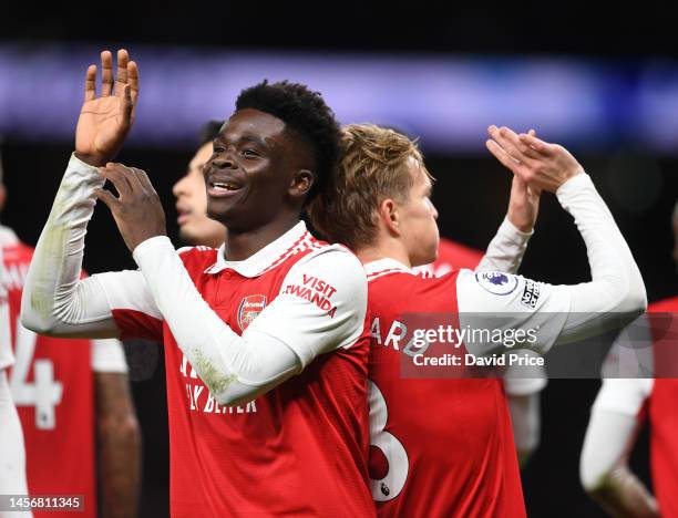 Martin Odegaard celebrates scoring Arsenal's 2nd goal with Bukayo Saka during the Premier League match between Tottenham Hotspur and Arsenal FC at...