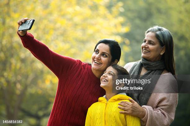 happy indian family taking selfie at park - indian mother daughter stock pictures, royalty-free photos & images