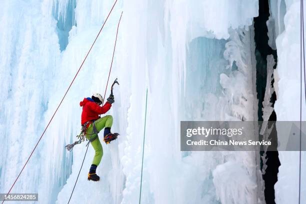 An ice climber scales a frozen waterfall at Yunmeng Gorge Scenic Spot on January 15, 2023 in Beijing, China.