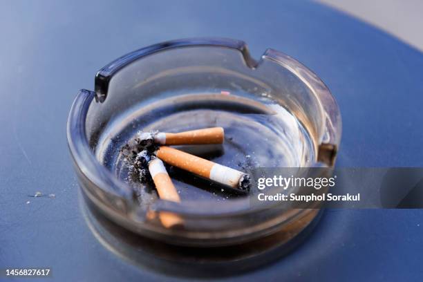ashtray containing cigaratte butts - ashtray stock pictures, royalty-free photos & images