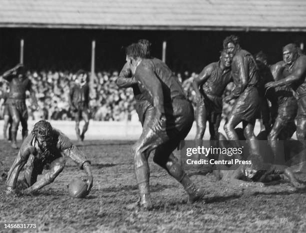 Doug McRitchie , Centre for the Australia Kangaroos rugby league team struggles to pick up the ball from a pass by half back team mate Keith Holman...