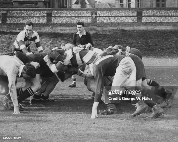 Bob Stuart, Captain of the touring New Zealand All Blacks rugby union team oversees a practice scrum during training on 30th October 1953 at...