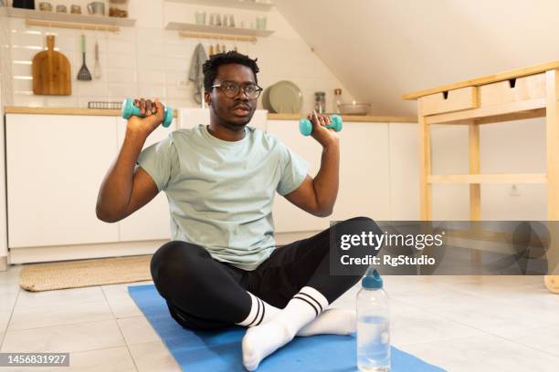 man exercising at home - lap body area stock pictures, royalty-free photos & images