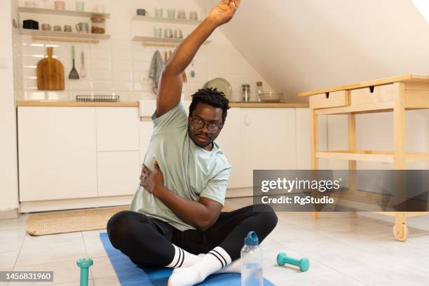 man exercising at home - lap body area stock pictures, royalty-free photos & images