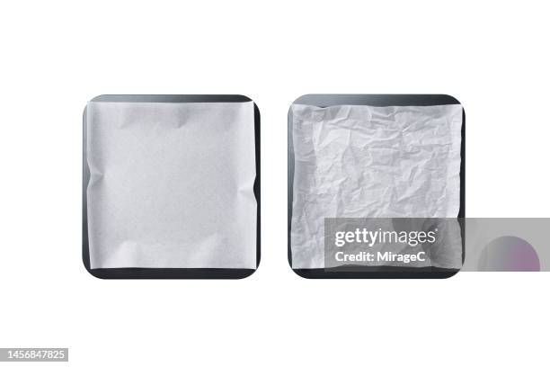 empty baking tray covered with baking paper isolated on white - wax paper fotografías e imágenes de stock