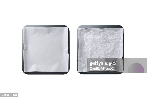 empty baking tray covered with baking paper isolated on white - baking tray stock pictures, royalty-free photos & images