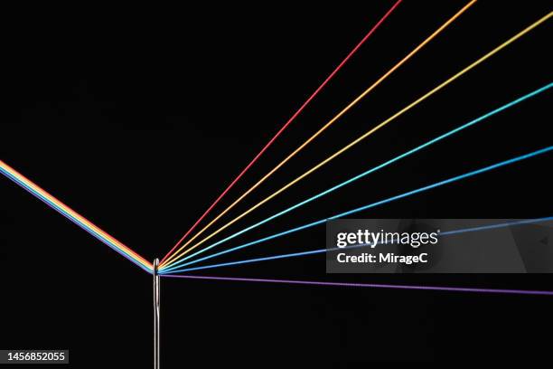 rainbow refraction by color threads through needle eyelet - spectre lumineux photos et images de collection