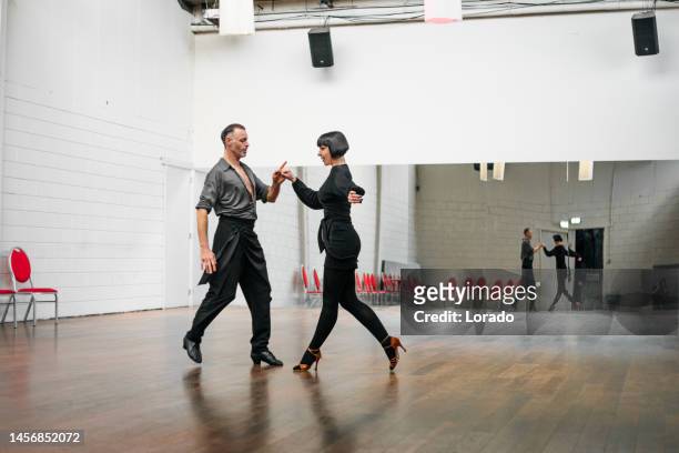 beautiful couple dancing jive together at a rehearsal area - swing dancing stock pictures, royalty-free photos & images