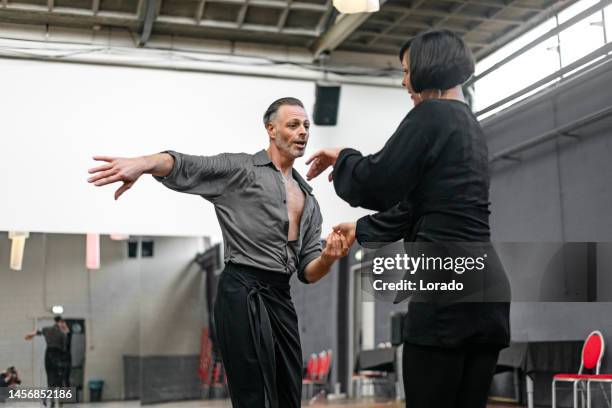 beautiful couple dancing jive together at a rehearsal area - swing dance stock pictures, royalty-free photos & images