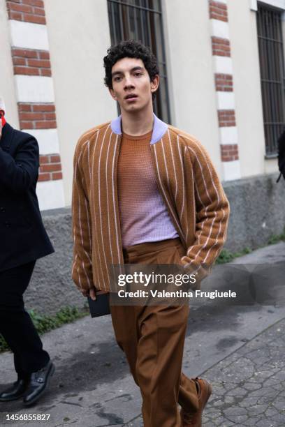 Actor Jorge Lopez is seen wearing a striped bomber jacket and brown pants outside the Zegna show during the Milan Menswear Fall/Winter 2023/2024 on...