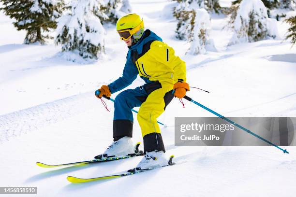 boy skiing in mountains in fir trees - ski pole stock pictures, royalty-free photos & images