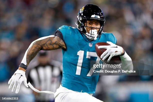 Evan Engram of the Jacksonville Jaguars carries the ball against the Los Angeles Chargers during the second half in the AFC Wild Card playoff game at...