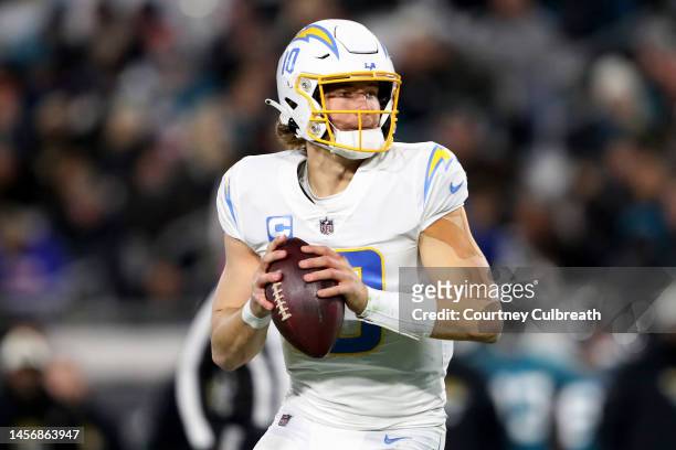 Justin Herbert of the Los Angeles Chargers looks to pass against the Jacksonville Jaguars during the first half of the game in the AFC Wild Card...