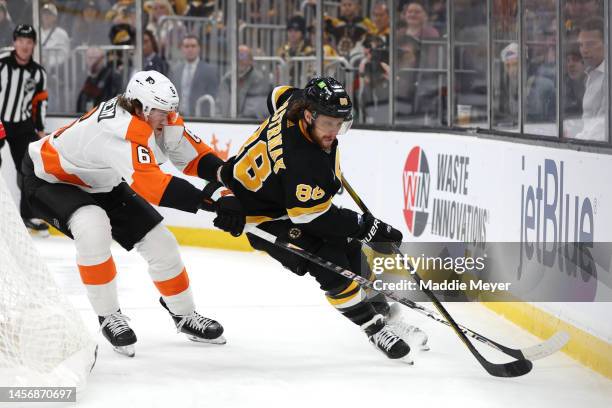 Travis Sanheim of the Philadelphia Flyers defends David Pastrnak of the Boston Bruins during the first period at TD Garden on January 16, 2023 in...