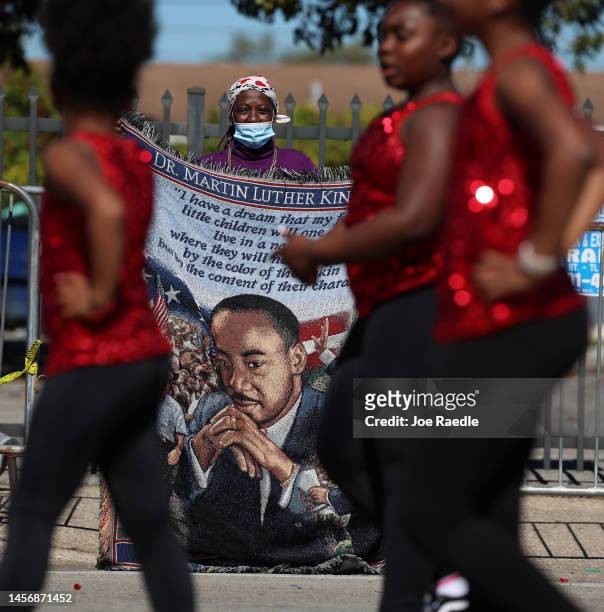 Diane McDonald holds a banner during the Dr. Martin Luther King Jr. Day Parade as it makes its way past in the Liberty City neighborhood on January...