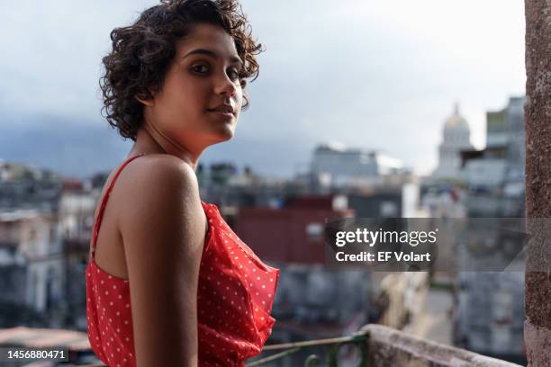 portrait of pretty young hispanic woman at home balcony in havana city cuba - open grave stock pictures, royalty-free photos & images