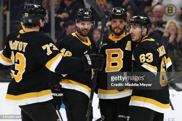 David Pastrnak of the Boston Bruins celebrates with Brad Marchand, David Krejci and Charlie McAvoy after scoring a goal against the Philadelphia...