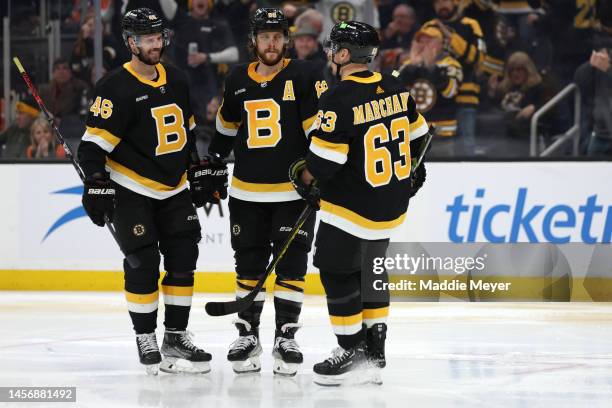 David Pastrnak of the Boston Bruins celebrates with Brad Marchand and David Krejci after scoring a goal against the Philadelphia Flyers during the...