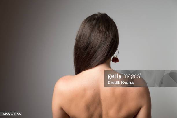 rear view of female torso with long brown hair - young women no clothes stock pictures, royalty-free photos & images