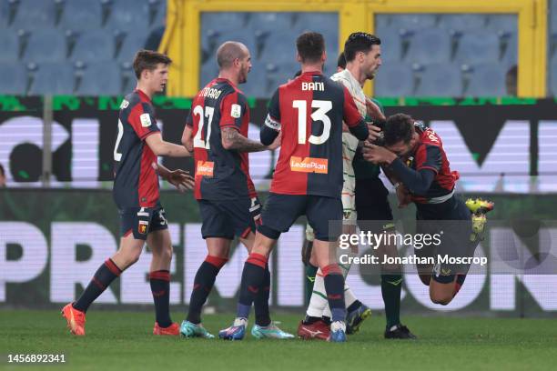 Team mates look on as Alessandro Vogliacco of Genoa CFC falls to the ground clutching his face following a clash with Ridgeciano Haps of Venezia FC...