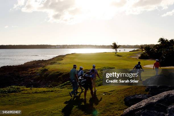 Wil Bateman, Michael Gellerman, and Evan Harmeling walk the 15th fairway during the second round of The Bahamas Great Exuma Classic at Sandals...