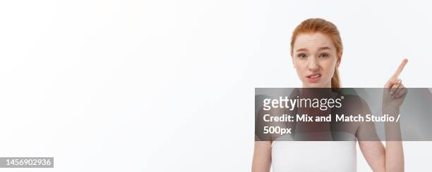 portrait of young woman against white background - on location for oblivion stock pictures, royalty-free photos & images