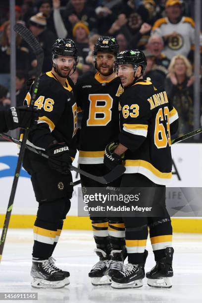 David Pastrnak of the Boston Bruins celebrates with Brad Marchand and David Krejci after scoring a goal against the Philadelphia Flyers during the...