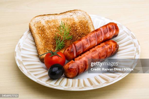close-up of sausages with roasted vegetables in plate on table,romania - sausages stock pictures, royalty-free photos & images