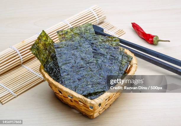 high angle view of food in wicker basket on table,romania - sushi nori foto e immagini stock