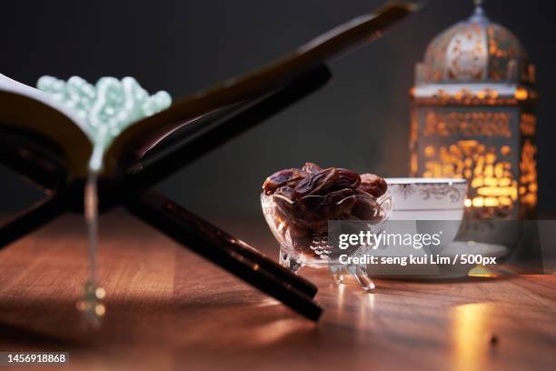 focus on bowl of date,hot tea koran and latern,malaysia - イフタール ストックフォトと画像