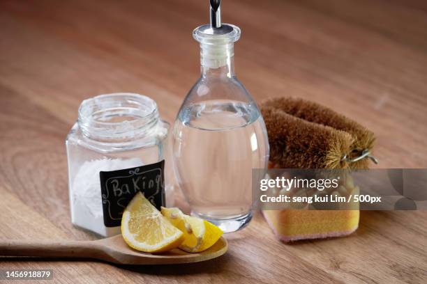 white vinegar baking soda and lemon on wooden table top,malaysia - aceto foto e immagini stock