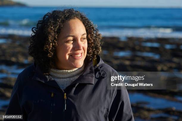 portrait of a woman at the coast - ordinary people stock pictures, royalty-free photos & images