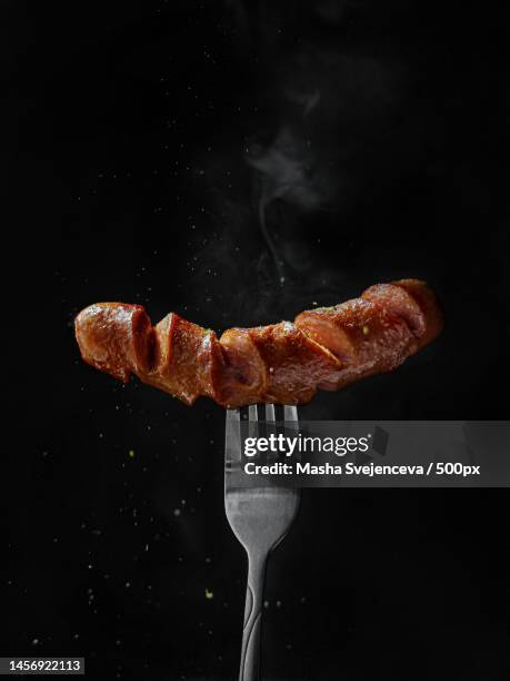 close-up of meat on barbecue grill - salchicha fotografías e imágenes de stock