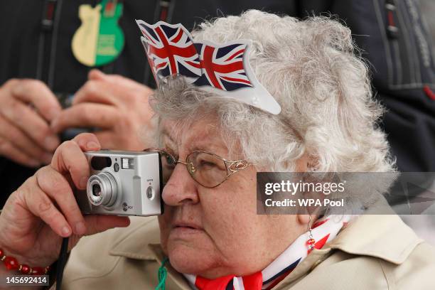 Woman takes a picture at a street party near Tower Bridge during the Thames Diamond Jubilee Pageant on the River Thames on June 3, 2012 in London,...