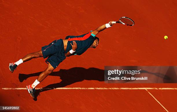 Jo-Wilfried Tsonga of France serves in his men's singles fourth round match against Stanislas Wawrinka of Switzerland during day 8 of the French Open...