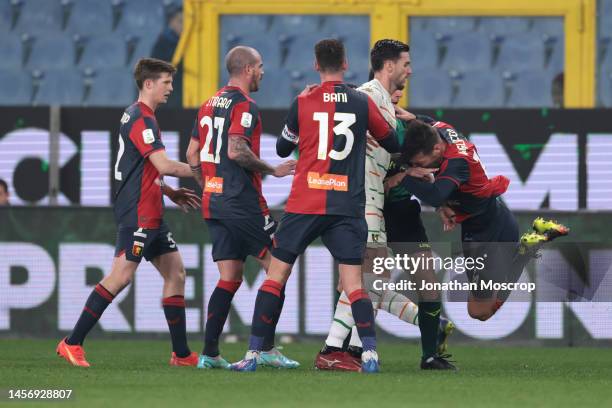 Team mates look on as Alessandro Vogliacco of Genoa CFC falls to the ground clutching his face following a clash with Ridgeciano Haps of Venezia FC...