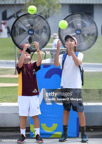 Tennis fans cool down beside water misting machines during day two of the 2023 Australian Open at Melbourne Park on January 17, 2023 in Melbourne,...
