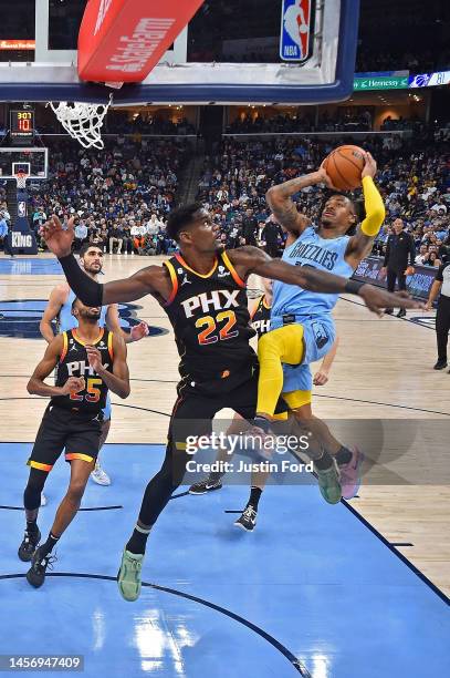 Ja Morant of the Memphis Grizzlies goes to the basket during the second half against Deandre Ayton of the Phoenix Suns at FedExForum on January 16,...