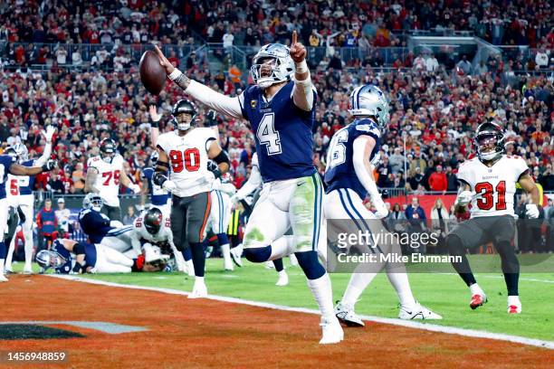 Dak Prescott of the Dallas Cowboys rushes for a touchdown against the Tampa Bay Buccaneers during the second quarter in the NFC Wild Card playoff...