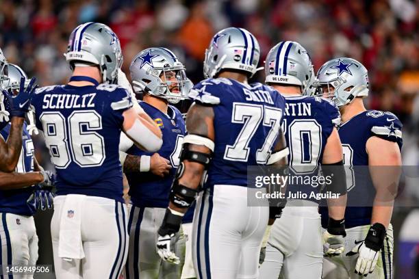 Dak Prescott of the Dallas Cowboys looks on in the huddle against the Tampa Bay Buccaneers during the first half in the NFC Wild Card playoff game at...