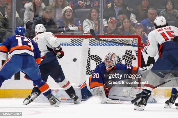 Dmitry Orlov of the Washington Capitals scores the game-winning goal in overtime against Ilya Sorokin of the New York Islanders at the UBS Arena on...