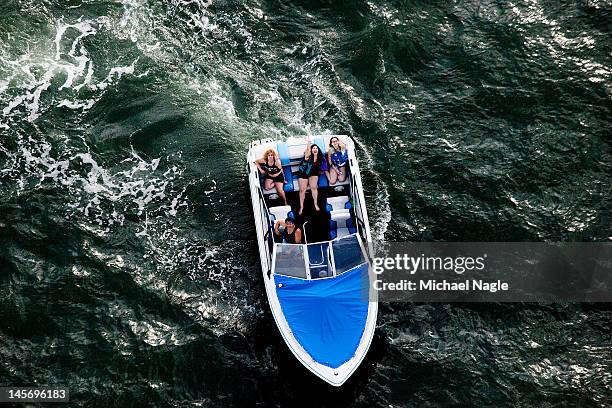 Group of people in a boat follow Space Shuttle Enterprise as it passes Coney Island on June 03, 2012 in New York City. Enterprise is on it's way to...