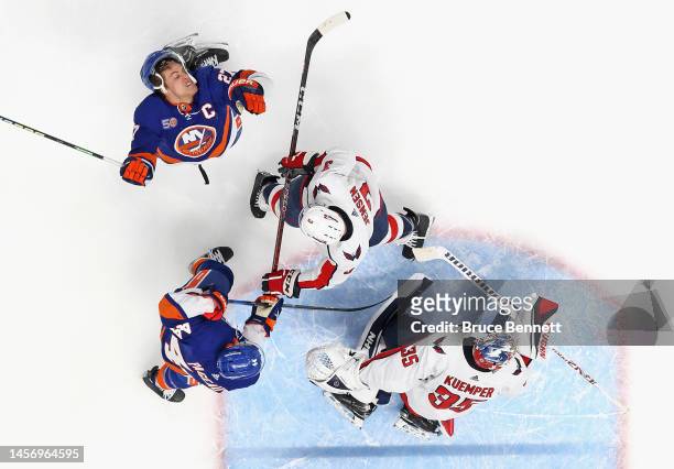 Anders Lee of the New York Islanders is hit by the stick of Nick Jensen of the Washington Capitals at the UBS Arena on January 16, 2023 in Elmont,...