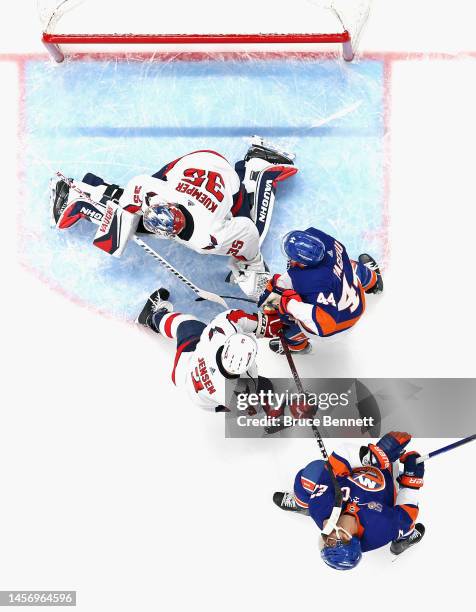 Anders Lee of the New York Islanders is hit by the stick of Nick Jensen of the Washington Capitals at the UBS Arena on January 16, 2023 in Elmont,...