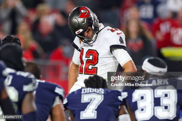 Tom Brady of the Tampa Bay Buccaneers looks on during an injury timeout during the fourth quarter against the Dallas Cowboys in the NFC Wild Card...