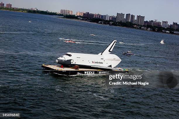 Space Shuttle Enterprise is carried by barge past Coney Island on June 03, 2012 in New York City. Enterprise is on it's way to the Intrepid Sea, Air...