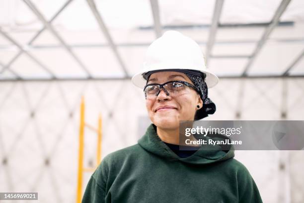 woman construction worker on job site - vakbond stockfoto's en -beelden