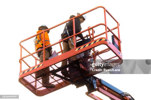 men working in large industrial man lift - high up stock pictures, royalty-free photos & images